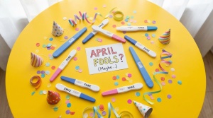 Fun, playful flat-lay of various fake pregnancy tests scattered on bright background with confetti and party elements. Lighth